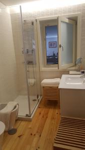 a bathroom with a shower and a toilet and a sink at SBV Perfect River View in Porto