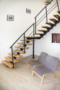 a chair in a room with a staircase at Casa das Pipas #4 in Pinhal Novo