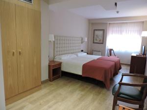 Postel nebo postele na pokoji v ubytování Hotel El Nogal