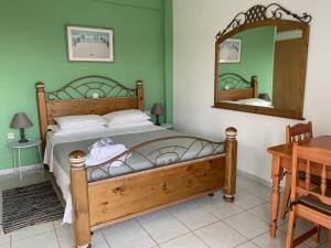 A bed or beds in a room at Anastasios Olive Garden Apartments