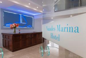a sign that reads yannis marina hotel in a store window at Naiades Marina Hotel in Agios Nikolaos