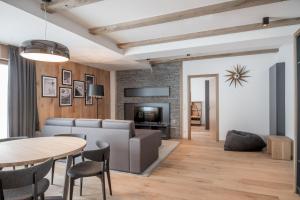 a living room with a couch and a table at Chalet Obergurgl Luxury Apartments in Obergurgl