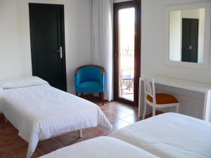 a bedroom with two beds and a mirror and a chair at Hotel Boutique Bon Repos - Adults Only in Santa Ponsa