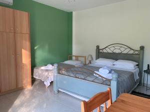 A bed or beds in a room at Anastasios Olive Garden Apartments