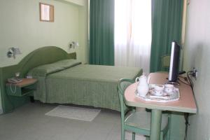 Postel nebo postele na pokoji v ubytování Hotel Grillo
