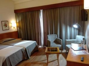 Postel nebo postele na pokoji v ubytování Hotel Do Centro