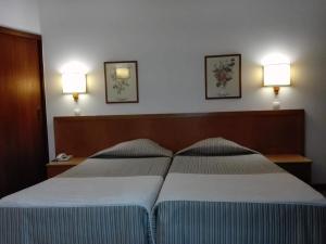 Postel nebo postele na pokoji v ubytování Hotel Do Centro