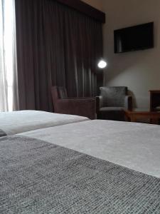 Postel nebo postele na pokoji v ubytování Hotel Do Centro
