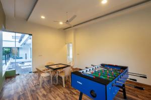 a living room with a table and a foos ball at SaffronStays Vedanta, Lonavala - villa with lawn, plunge pool and indoor games near Tungarli Lake in Lonavala