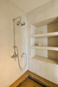 a bathroom with a shower and shelves in it at White Memories, seafront luxury apartment Mykonos in Mýkonos City