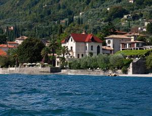 a town on the shore of a body of water at Hotel Villa Giulia in Gargnano