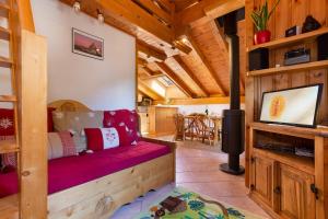 a living room with a red couch in a cabin at Village des Oursons Chalet B - Happy Rentals in Chamonix-Mont-Blanc