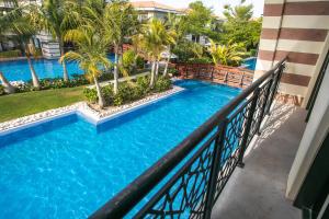 a view of a swimming pool from a balcony of a resort at Zabeel Saray Royal Residences Lagoon Villa in Dubai