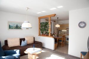 a living room with a couch and a table at Landhaus Manuela & Haus Michael in Leutasch