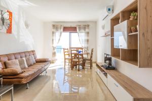 a living room with a couch and a table at Apartamento Correia in Albufeira