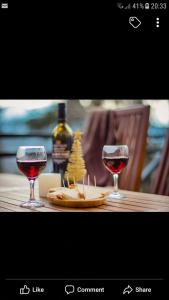 two glasses of wine sitting on a wooden table at ELSADA in Stepantsminda