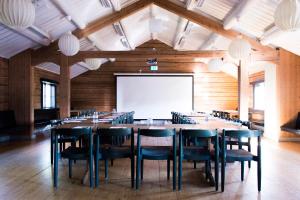 a large conference room with a large table and chairs at Marsfjäll Mountain Lodge Hotell i Saxnäs in Saxnäs