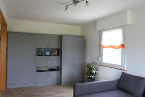 a living room with a couch and a window at Ferienhaus Rosental in Wanfried