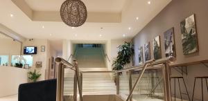 a staircase in a house with a glass railing at The Grand Motel in Griffith