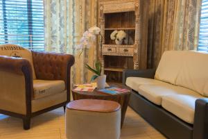 a living room with a couch and a table at Tradewinds Apartment Hotel Miami Beach in Miami Beach