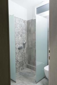 a bathroom with a shower and a toilet at Thalassoresort DOWNSTAIRS in Matala