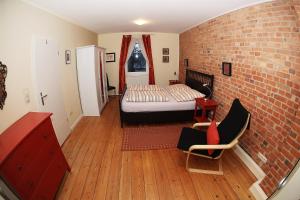 a bedroom with a bed and a brick wall at Jessop Haus in Lübeck