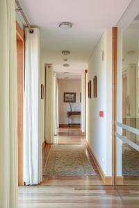- un couloir avec des rideaux blancs et une table dans la chambre dans l'établissement Hotel Rural Quinta Do Pego, à Tabuaço