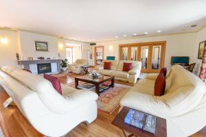 a living room with white furniture and a fireplace at Hotel Rural Quinta Do Pego in Tabuaço