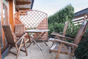 a pair of chairs and a table on a patio at Domek Osada Gubałówka Zakopane in Słodyczki