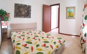 een slaapkamer met een bed met een kleurrijk dekbed bij La Quiete 27 Lake view by Gardadomusmea in Tremosine Sul Garda +28 foto's