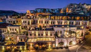 a large white building with lights at night at Carus Cappadocia in Göreme