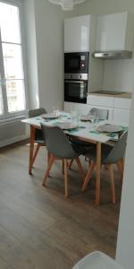 a kitchen with a table with wine glasses on it at Cannes la bocca appartement in Cannes
