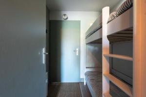 a bedroom with a bunk bed and a door to a hallway at Green Suite Golfe de Saint Tropez in Gassin +24 photos
