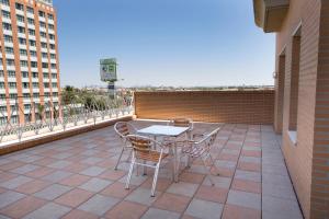 a patio with a table and chairs on a building at Aparthotel Albufera in Alfafar