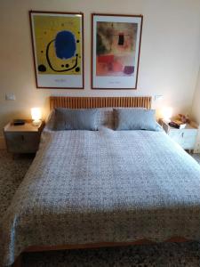 a bedroom with a bed with two pictures on the wall at Apartment in Molino Stucky in Venice