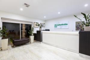 a store lobby with a counter and plants at Morphettville Motor Inn in Glenelg