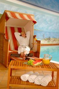 a woman laying in a bed in a toy house at Ferienpark Heidenholz in Plau am See