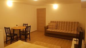 a living room with a couch and a table at SAULES SVECIU NAMAI in Palanga