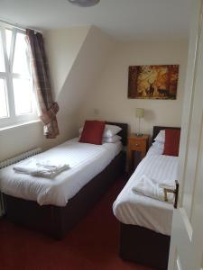 a hotel room with two beds and a window at The Station Hotel in Alness
