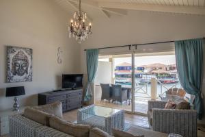 a living room with a view of a boat at Ocean Blue Bonaire in Kralendijk