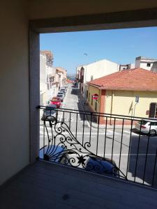 a balcony with a view of a street with cars at B&B Nino in Olbia