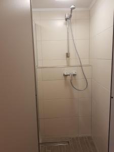 a shower with a glass door in a bathroom at Ferienhaus an der Sesselbahn in Cochem
