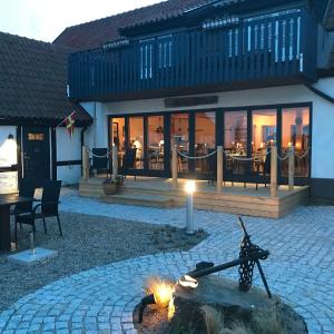 a fire pit in front of a building with a restaurant at Bobergs på Hamngården in Brantevik +64 photos