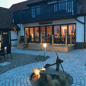 a fire pit in front of a building with a restaurant at Bobergs på Hamngården in Brantevik