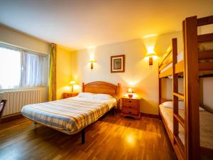 a bedroom with a bed and a bunk bed at Achafla Baita in Ascain