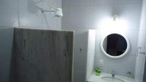 a bathroom with a sink and a mirror at Hotel Praia do Futuro in Fortaleza