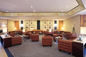a living room filled with couches and chairs at Starhotels President in Genoa