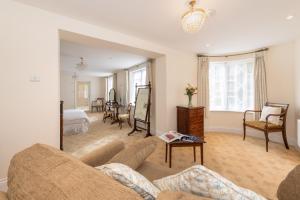 a living room with a couch and a bedroom at Royal Glen Hotel in Sidmouth +30 photos
