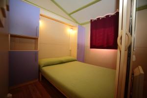 A bed or beds in a room at Camping Dal Pino