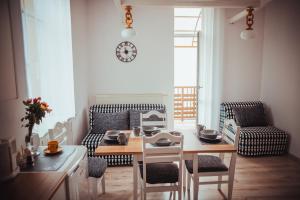 a living room with a table and chairs and a clock at nocleg blisko dworca Krosno in Krosno